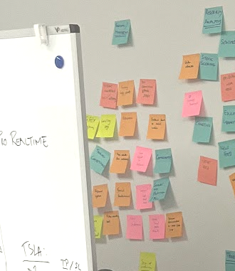Wall covered in sticky notes listing exchange features